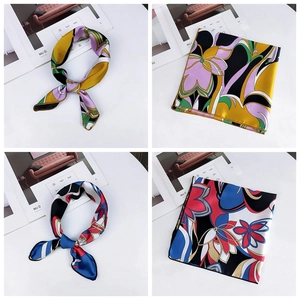 Detail of square silk scarf showing floral print patterns and knotting styles on white background