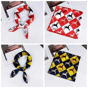 Detail view of square silk scarf with pixelated horse prints in red and yellow colorways