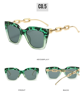 Detail view of square sunglasses featuring dark green leopard frames and gold chain temples