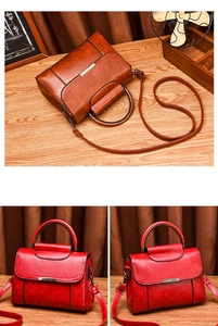 Detail of vintage oil wax leather handbag with cylindrical metal handle and crossbody strap