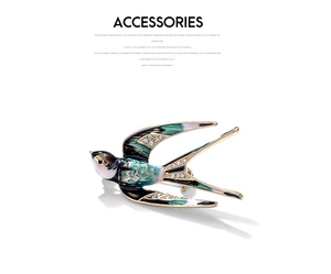 Detail showing enamel swallow brooch with blue green wings and inlaid crystals