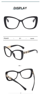 Close-up of cat-eye glasses with geometric gold metal accents on black temples, model PGJ421