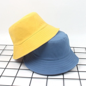 Close-up of yellow and navy cotton fisherman hats with reinforced stitching details