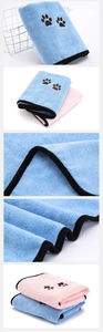 Close-up of microfiber pet towel showing paw embroidery and soft fabric texture