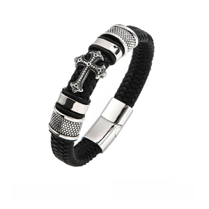 Detail of black braided leather bracelet featuring a vintage silver cross and magnetic clasp