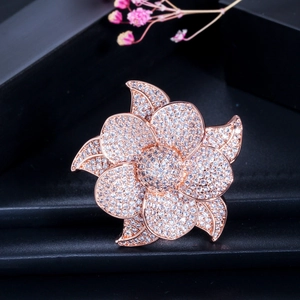 Detailed view of rose gold flower ring with AAA cubic zirconia on dark leather