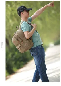 Side view of a khaki washed canvas backpack with leather pulls in an outdoor setting