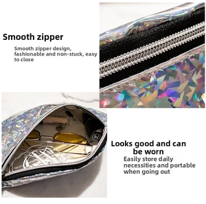 Detail of silver holographic waist bag showing smooth zipper and spacious interior compartment