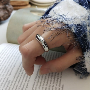 Detailed view of polished 925 sterling silver wide band ring with smooth convex surface