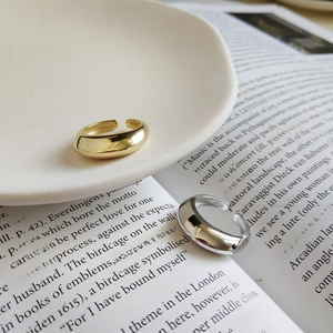 Detailed close-up of S925 sterling silver stamp on minimalist gold and silver rings