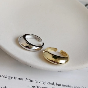 Detail shot of gold and silver S925 sterling silver wide rings with minimalist texture