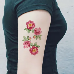 Detailed realistic rose flower temporary tattoo sticker applied on model arm