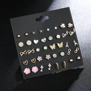 36 pairs of diverse stud earrings featuring Eiffel Tower and pearls on a display card