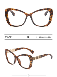 Detail of tortoise shell cat eye frames with gold metal geometric temple accents