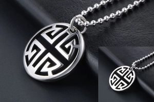 Macro shot of silver pendant with traditional hollowed geometric patterns on leather