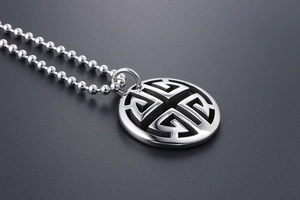 Close-up of vintage hollow geometric round pendant on long silver chain necklace