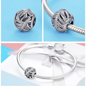 Detailed macro view of S925 sterling silver hollow charm with white zircon on snake chain