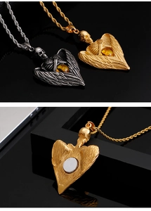 Detail of skull angel wings pendant with amber gemstone and magnetic back feature