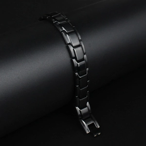 Detail shot of men's titanium steel magnetic therapy bracelet with polished gold and black links