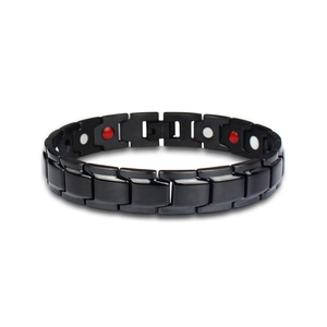 Close-up of black magnetic therapy bracelet with H-link design and red-white magnets