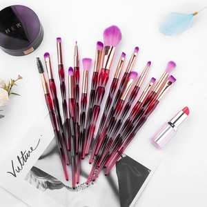 Detail of 15 makeup brushes with red diamond crystal handles and purple gradient bristles