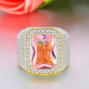 Macro shot of an octagonal orange gem set in a gold ring with micro-pave zircons