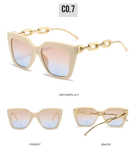 Detail view of oversized beige square frame sunglasses with golden chain temples and gradient lenses