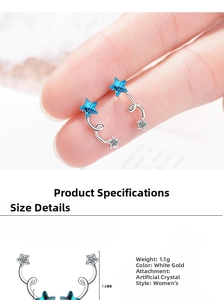 Macro shot of 16mm blue crystal star crawler earrings in white gold plating