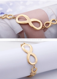 Macro view of gold infinity symbol link bracelet with polished metallic finish