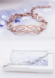 Detail of infinity figure eight link chain bracelets in rose gold and silver finishes