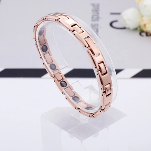 Polished rose gold titanium steel magnetic therapy bracelet for women on display stand