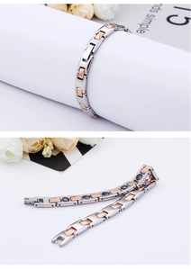 Detail of two-tone titanium steel magnetic bracelet in silver and rose gold with magnets