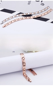 Detail of minimalist fine steel chain bracelets in silver and rose gold finishes