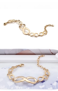 Detailed close-up of golden infinity link bracelet with a secure lobster clasp