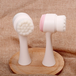 Double-sided manual facial cleansing brush with soft bristles and silicone massage pad