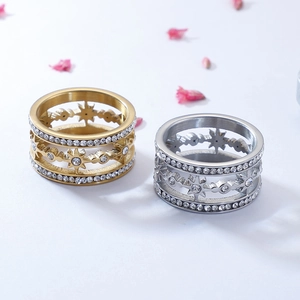 Star-shaped zircon inlaid stainless steel rings in gold and silver colors on white background