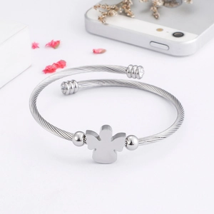 Silver angel-shaped steel wire bracelet with sparkling zircons on white background