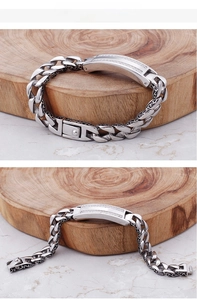 Detailed view of men's stainless steel curb bracelet with zircon inlays and retro patterns