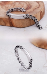 Detailed macro of men's stainless steel punk bracelet with micro-pave cubic zirconia