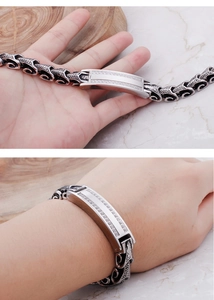 Detail of retro silver dragon chain bracelet with pave zircons on curved metal plate