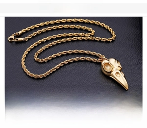 Detail view of 18K gold plated stainless steel bird skull pendant with rope chain necklace