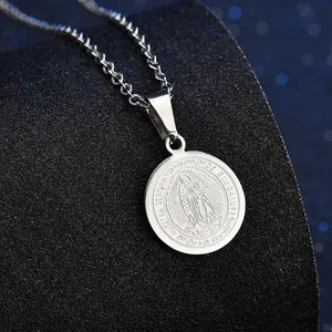 Detalle de collar con medalla de la Virgen María y colgante circular de plata grabada