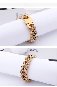 Close-up of gold Cuban link bracelet with micro-pave crystals and metal buckle detail