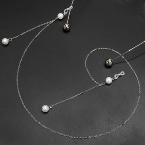 Silver alloy chain eyewear holder with white pearls and metal beads on black background