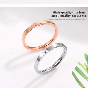 Detail of rose gold and silver slim titanium rings with square cubic zirconia setting