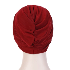 Detailed back view of deep red turban featuring a unique twisted knot and pleated design
