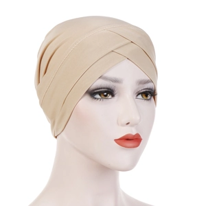 Detailed side view of beige elastic turban hat featuring front cross pleated design