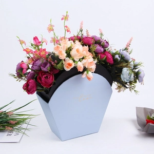 Detail view of light blue envelope-style cardboard flower box with colorful silk roses
