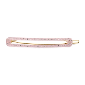 Detail of pink acetate hair clip with sparkling rhinestones and golden metal base