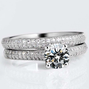 Macro shot of micro-pave set simulated diamond wedding ring set with brilliant round center stone